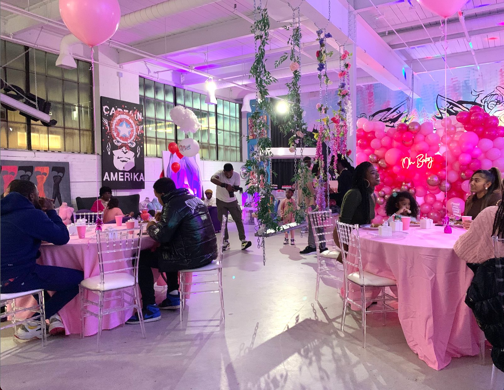 A celebration in the gallery with balloons and dressed tables