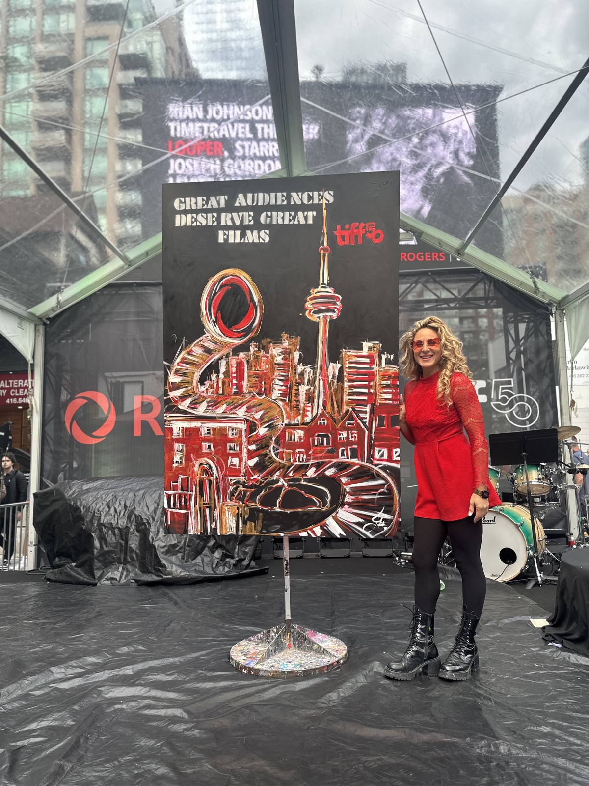 Jessica beside her live painting of the Toronto skyline for TIFF's 50th, on the Rogers stage