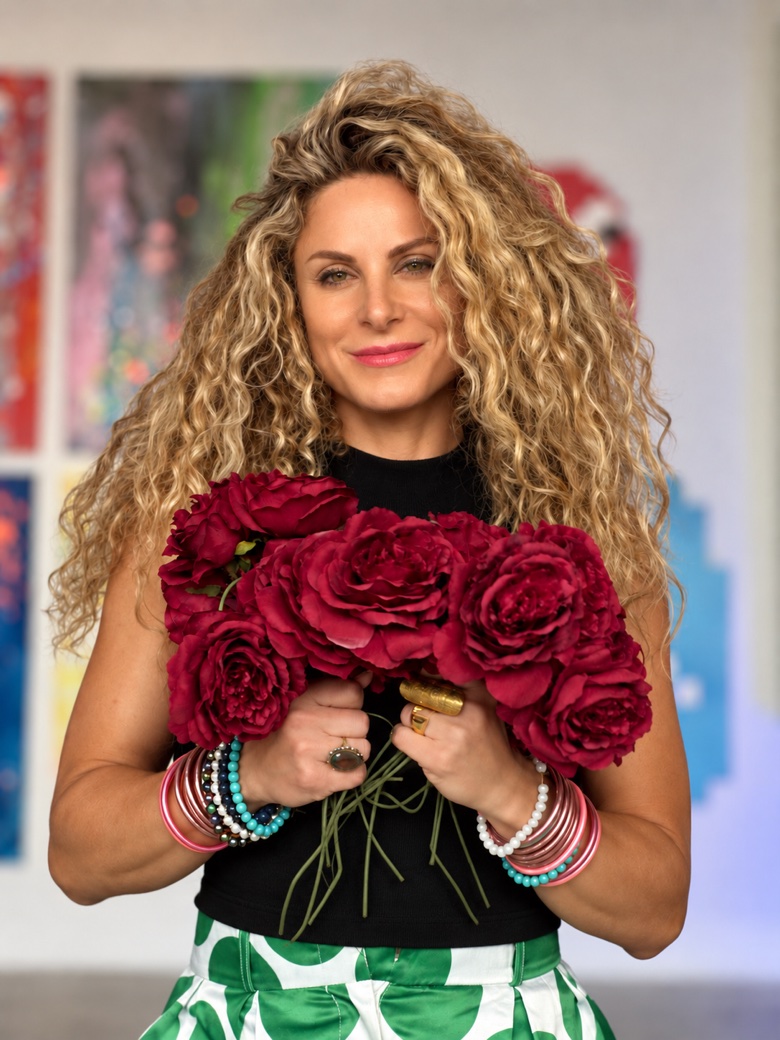 Jessica Gorlicky holding a bouquet of red roses in her gallery